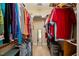This walk-in closet is fully stocked and provides a view into the Primary bathroom at 8437 Little Woody Ct, Zebulon, NC 27597
