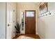 Inviting entryway with wood floors, decorative wallpaper, and stylish hooks at 8437 Little Woody Ct, Zebulon, NC 27597