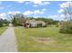 Spacious home with a large grassy yard, mature trees, and a private driveway at 8437 Little Woody Ct, Zebulon, NC 27597