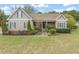 Charming single-story home with a well-manicured lawn and inviting front porch with a red door at 8437 Little Woody Ct, Zebulon, NC 27597