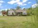 Attractive single-Gathering home with lush landscaping and a welcoming front porch at 8437 Little Woody Ct, Zebulon, NC 27597