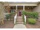 Close-up of the inviting front porch with brick steps and decorative greenery at 8437 Little Woody Ct, Zebulon, NC 27597