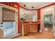 The kitchen bar area features wood cabinets and granite countertops, offering views to other rooms at 8437 Little Woody Ct, Zebulon, NC 27597