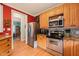 Kitchen with stainless steel appliances, light wood cabinets, and a tiled backsplash at 8437 Little Woody Ct, Zebulon, NC 27597