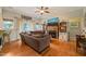 Cozy living room showcases hardwood floors, fireplace, and natural light from the windows at 8437 Little Woody Ct, Zebulon, NC 27597