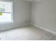 Bright bedroom with fresh paint, base trim and natural light at 905 Linwood Ave, Durham, NC 27701