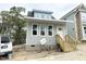 Charming gray home with bright windows and inviting entryway with wood stairs at 905 Linwood Ave, Durham, NC 27701