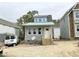 Charming home exterior with a white front door, large windows, and new wooden steps at 905 Linwood Ave, Durham, NC 27701