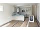 Kitchen featuring gray cabinets and a breakfast bar, awaiting the finishing touches at 905 Linwood Ave, Durham, NC 27701