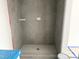 Modern shower featuring gray tiling and a sleek design, creating a luxurious bathing experience at 905 Linwood Ave, Durham, NC 27701