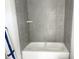Bright bathroom featuring a new tub with gray tiling at 905 Linwood Ave, Durham, NC 27701