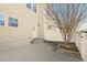 Private backyard showcasing patio area, landscaping and access door with wooden steps at 912 Ambergate Sta, Apex, NC 27502
