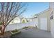Private backyard patio with white fence, landscaping, and convenient storage access to the side of the home at 912 Ambergate Sta, Apex, NC 27502