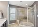 Tiled bathroom shower with a glass door and seat at 912 Ambergate Sta, Apex, NC 27502