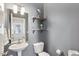 Bathroom with pedestal sink, decorative shelves, and neutral gray walls at 912 Ambergate Sta, Apex, NC 27502