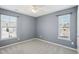 Bedroom featuring carpet floor and two windows with blinds at 912 Ambergate Sta, Apex, NC 27502