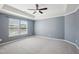 Spacious bedroom with tray ceiling, neutral carpet, and a large window providing natural light at 912 Ambergate Sta, Apex, NC 27502