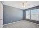Bedroom featuring carpet floor, windows and blue and white patterned wall at 912 Ambergate Sta, Apex, NC 27502