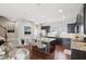 Open-concept kitchen with granite countertops, stainless steel appliances, hardwood floors, and modern island with seating at 912 Ambergate Sta, Apex, NC 27502
