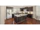 Eat-in kitchen featuring stainless appliances, granite countertops and a spacious island at 912 Ambergate Sta, Apex, NC 27502
