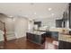 Eat-in kitchen with granite countertops, stainless appliances, island with seating, and hardwood floors at 912 Ambergate Sta, Apex, NC 27502