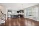 Open kitchen with stainless steel appliances, a center island, and dark wood flooring at 912 Ambergate Sta, Apex, NC 27502