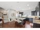 Eat-in kitchen with granite countertops, stainless appliances, island with seating, and hardwood floors at 912 Ambergate Sta, Apex, NC 27502