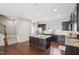 Well-equipped kitchen with a center island, modern appliances, ample cabinet space, and hardwood floors at 912 Ambergate Sta, Apex, NC 27502
