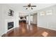 Open-concept living room with a fireplace, hardwood floors, and seamless flow into the kitchen and dining areas at 912 Ambergate Sta, Apex, NC 27502