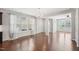 Bright living room with hardwood floors, large windows, and an open design leading into other living spaces at 912 Ambergate Sta, Apex, NC 27502