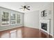 Inviting living room with a fireplace, large windows providing natural light, and hardwood floors at 912 Ambergate Sta, Apex, NC 27502