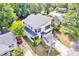 Aerial view of a modern two-story home with mature trees, a manicured lawn, and proximity to neighborhood streets at 915 S State St, Raleigh, NC 27601
