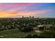Aerial view showcasing the city skyline at sunset with lush green surroundings at 915 S State St, Raleigh, NC 27601