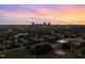 Scenic aerial view featuring skyline and verdant landscape under a vibrant sunset sky at 915 S State St, Raleigh, NC 27601