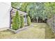 Landscaped backyard features well-maintained lawn, mature trees, a storage shed, and a climbing wall for outdoor fun at 915 S State St, Raleigh, NC 27601