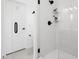 Modern tiled shower with glass door and white herringbone patterned accent wall at 915 S State St, Raleigh, NC 27601