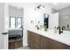 Modern bathroom with double vanity, stone countertops, and adjoining bedroom at 915 S State St, Raleigh, NC 27601