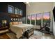 Bright bedroom featuring multiple windows, high ceilings, accent wall, and exercise bike at 915 S State St, Raleigh, NC 27601