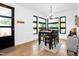 Bright dining room featuring a modern light fixture and a dark wood table with seating for four at 915 S State St, Raleigh, NC 27601
