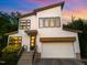 Beautiful two-story home with a modern design, striking windows reflecting sunset, and a well-manicured lawn at 915 S State St, Raleigh, NC 27601