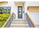 Close-up of a modern front door with a glass pane, wooden accents, and stylish hardware at 915 S State St, Raleigh, NC 27601