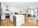 Open-concept kitchen with stainless steel appliances, a center island, and a view of the living room at 915 S State St, Raleigh, NC 27601