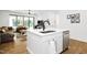 Modern kitchen island with seating, with an open view of the adjacent living area and backyard at 915 S State St, Raleigh, NC 27601