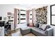 Inviting living room area with stylish gray sofa, floral decor, and bright windows allowing in natural light at 915 S State St, Raleigh, NC 27601