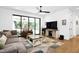 Inviting living room with modern decor, a ceiling fan, and a sliding glass door leading to the outdoors at 915 S State St, Raleigh, NC 27601