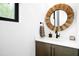 Stylish powder room with wood mirror, modern vanity, stone countertop, and black faucet at 915 S State St, Raleigh, NC 27601