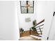 Modern staircase with hardwood treads, black railings, shiplap wall, and bright natural light at 915 S State St, Raleigh, NC 27601