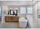 Elegant bathroom with a standalone tub, wood vanity and modern fixtures at 97 August Trace Dr, Pittsboro, NC 27312