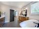 Chic bathroom featuring a sleek freestanding tub, wood cabinetry, and modern lighting at 97 August Trace Dr, Pittsboro, NC 27312