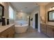 Luxury bathroom with a freestanding tub, dual vanities, and a glass-enclosed shower at 97 August Trace Dr, Pittsboro, NC 27312